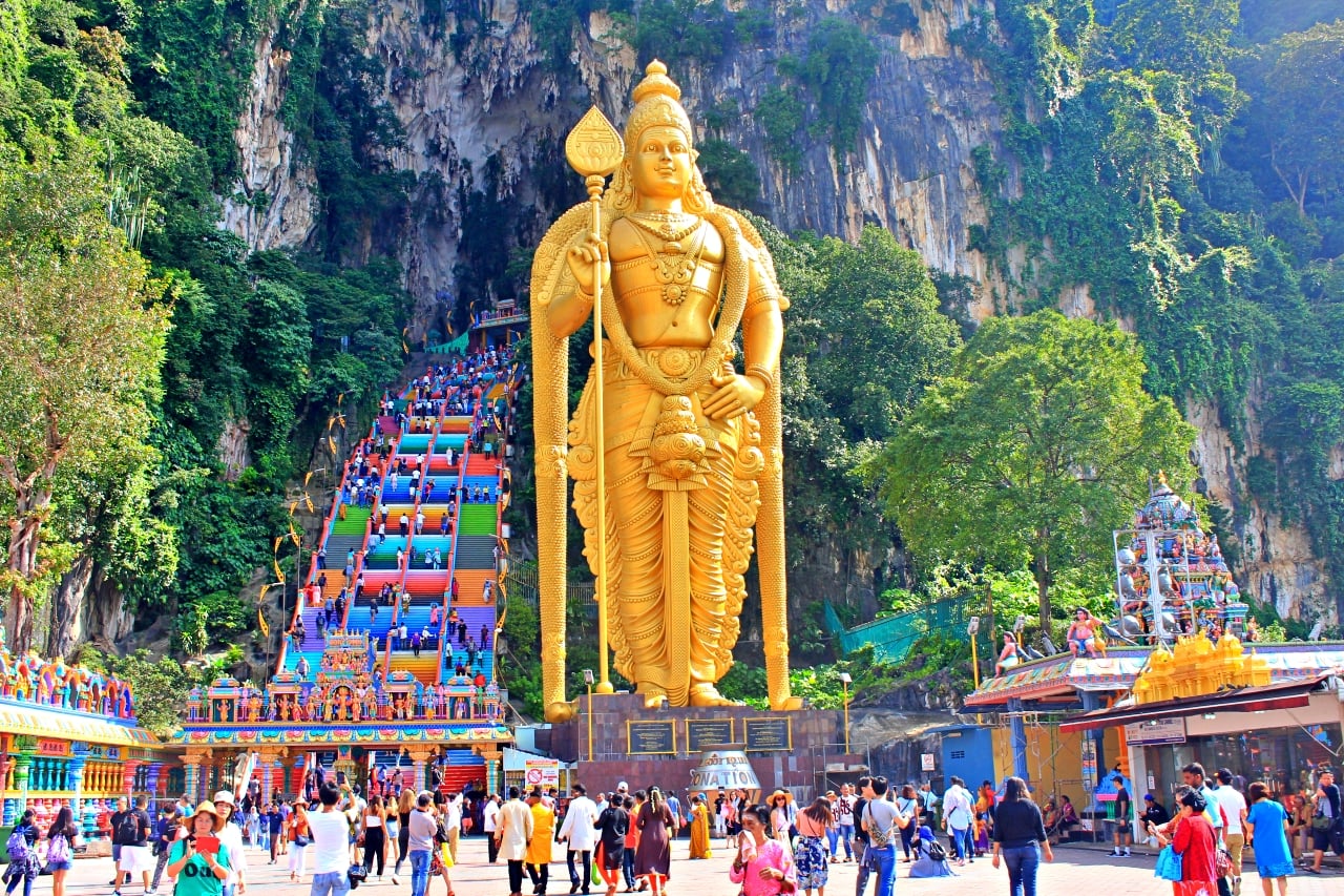 Golden Murugan statue and colorful steps at Batu Caves, Malaysia
